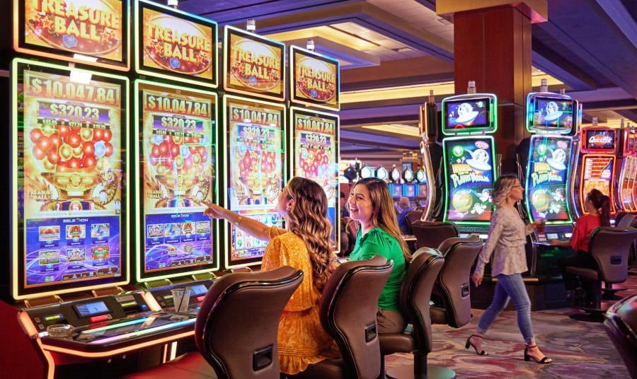 Two girls playing slots